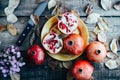 Ripe pomegranate fruit on wooden vintage background. Red juice p Royalty Free Stock Photo