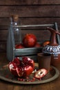 Ripe pomegranate fruit on wooden vintage background. Red juice pomegranate on dark background. Fresh juicy pomegranate - Royalty Free Stock Photo