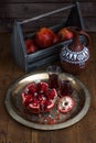 Ripe pomegranate fruit on wooden vintage background. Red juice pomegranate on dark background. Fresh juicy pomegranate - Royalty Free Stock Photo