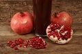 Ripe pomegranate fruits with glass of juice on wooden table Royalty Free Stock Photo