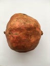 Ripe pomegranate with a textured peel. Macro shot.