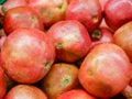 Ripe pomegranates on the counter. Collection of grenades in a shop window. close-up. New Year fruit concept, freshly squeezed Royalty Free Stock Photo