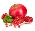 Ripe pomegranates with leaves close-up on a white background. Royalty Free Stock Photo