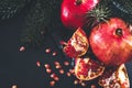 Ripe red pomegranates , fir branches on a dark background Royalty Free Stock Photo