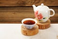 Ripe puerh tea in white bowl brewed in white porcelain pot