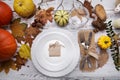 Ripe pumpkin cutlery glass and yellow leaves on a wooden table Royalty Free Stock Photo