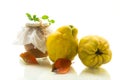 Ripe quince fruit with jam in a glass jar isolated on a white background