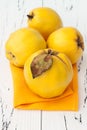 Ripe quinces on vintage wooden table