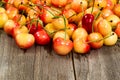 Ripe Rainier cherries on aged wooded table Royalty Free Stock Photo