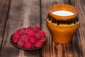 Ripe raspberry and milk jug Royalty Free Stock Photo