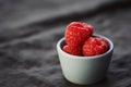 ripe raspberry in a small blue bowl on a linen background with copy space Royalty Free Stock Photo