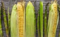 Ripe raw natural corn and asparagus on wooden table Royalty Free Stock Photo