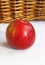 Ripe red appetizing apple on a basket and white background Royalty Free Stock Photo