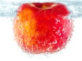 Ripe red apple with bubbles underwater Royalty Free Stock Photo