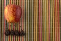 Ripe red Apple and dried pear on the colorful Mat made of bamboo Royalty Free Stock Photo