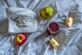 ripe red apple green pear smoothie glass and david eye sculpture on white fabric drapery with folds in light Royalty Free Stock Photo