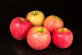 Ripe red apples lie on the table, black background Royalty Free Stock Photo