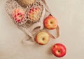 Ripe red apples in a light string bag on a beige background close-up Royalty Free Stock Photo
