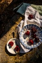 Ripe red cherries in antique blue and white bowl with silver spoon Royalty Free Stock Photo