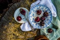 Ripe red cherries in antique blue and white bowl with silver spoon Royalty Free Stock Photo