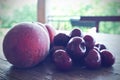 Ripe red cherries and peaches on wooden table, retro filtered Royalty Free Stock Photo