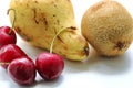 Ripe red cherry berries with yellow pear and kiwi on a white background Royalty Free Stock Photo