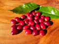 red coffee cherries arabica on a wooden table