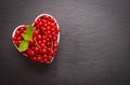 Ripe red currant berry in a heart shaped dish Royalty Free Stock Photo