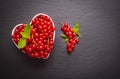 Ripe red currant berry in a heart shaped dish Royalty Free Stock Photo