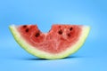 ripe red juicy watermelon slice bitten off on a blue background Royalty Free Stock Photo