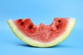 ripe red juicy watermelon slice bitten off on a blue background Royalty Free Stock Photo