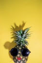 Ripe red lips pineapple with sunglasses on yellow background, copy space, minimal summer concept Royalty Free Stock Photo