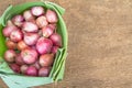 Ripe red onions in banana leaf on vintage grunge wooden background