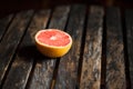 Ripe red orange on wooden table, cross section Royalty Free Stock Photo