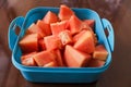 Ripe red papaya fruit that has been cut, in a purple box, on the table Royalty Free Stock Photo