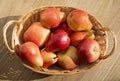 Ripe red pears and apple in the rod basket on the wooden table Royalty Free Stock Photo