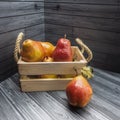 Ripe red pears are packed in a wooden box