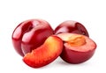 Ripe red plums, half and piece on a white, isolated Royalty Free Stock Photo