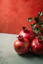 Ripe red pomegranates on a coral background