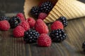 Ripe red raspberries in a crispy waffle cone