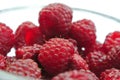 Ripe red raspberries in a glass bowl closeup Royalty Free Stock Photo