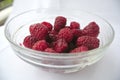 Ripe red raspberries in a glass bowl Royalty Free Stock Photo