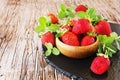 Ripe red raspberries and strawberries in wooden bowl, selective focus Royalty Free Stock Photo