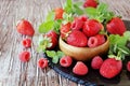 Ripe red raspberries and strawberries in wooden bowl, selective focus Royalty Free Stock Photo