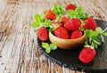 Ripe red raspberries and strawberries in wooden bowl, selective focus Royalty Free Stock Photo