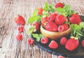 Ripe red raspberries and strawberries in wooden bowl, selective focus Royalty Free Stock Photo