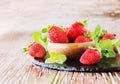 Ripe red raspberries and strawberries in wooden bowl, selective focus Royalty Free Stock Photo