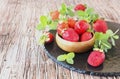 Ripe red raspberries and strawberries in wooden bowl, selective focus Royalty Free Stock Photo