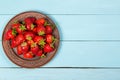 Ripe red strawberries on a blue wooden background Royalty Free Stock Photo