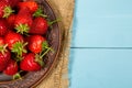 Ripe red strawberries on a blue wooden background Royalty Free Stock Photo